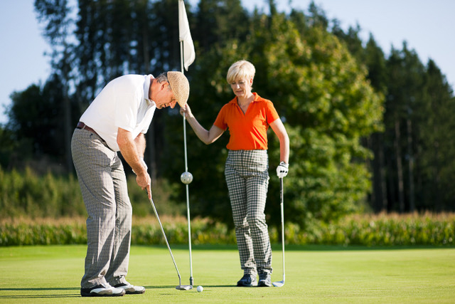 Retired couple golfing the Troy Burne Golf Course in Troy Burne Golf Village. www.durhamexecutivegroup.com