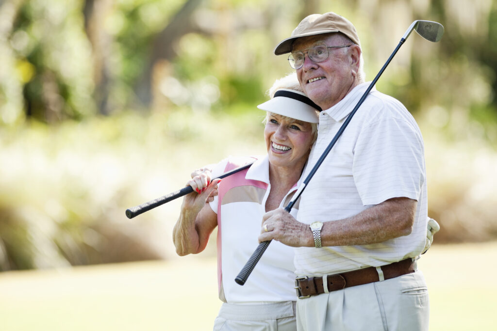 Senior couple, enjoying retirement on the Troy Burne Golf Village golf course