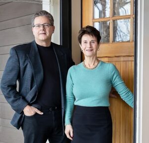 Realtors, John and Becky Durham in front of a home. www.durhamexecutivegroup.com